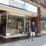 Mike Quick, owner, in front of Crescent Frame Shoppe